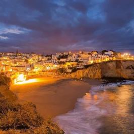 a train crossing a bridge over a body of water