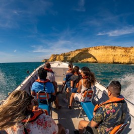 a group of people standing next to a body of water