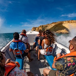 a group of people sitting at a beach