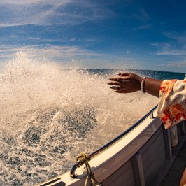 a person riding on the back of a boat