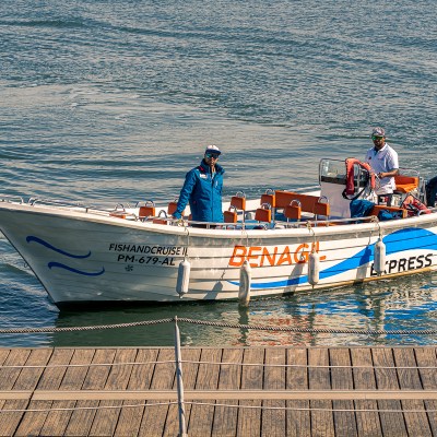 a man riding on the back of a boat in the water