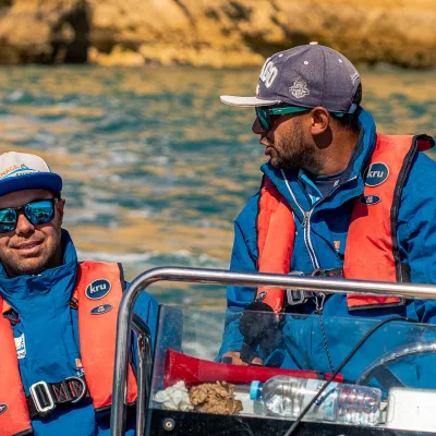 a group of people riding on the back of a boat
