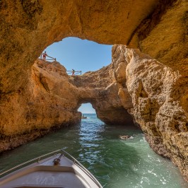 a person sitting on a rock next to water