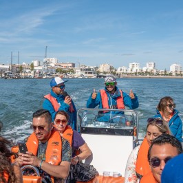 Roy Paci et al. in a boat on a body of water