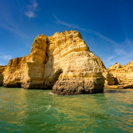 a large body of water with a mountain in the background