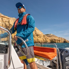 a man sitting on top of a mountain