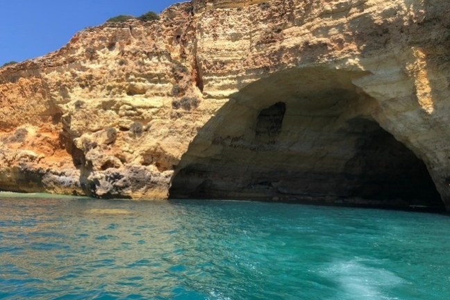 a rocky island in the middle of a body of water