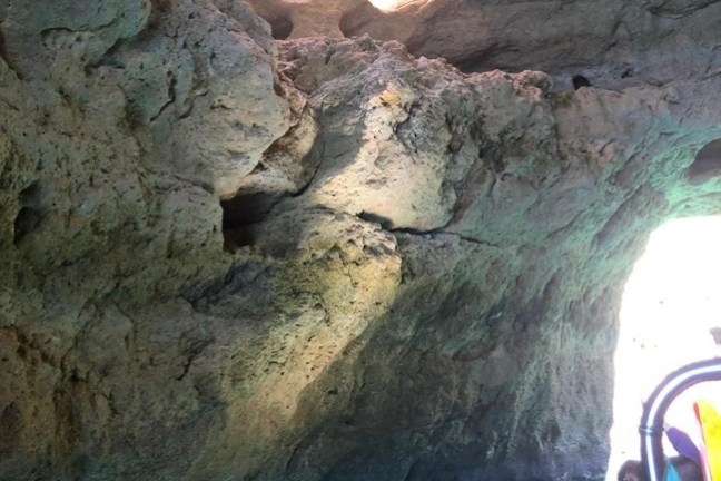 a man sitting on a rock in a pool of water